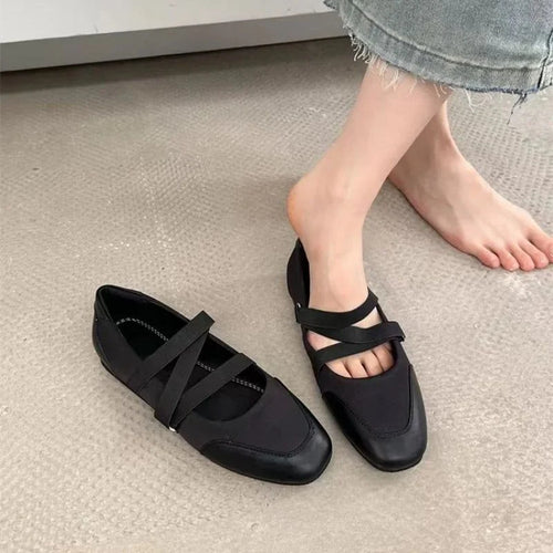 une ballerine portée et l’autre posée au sol près d’un pied