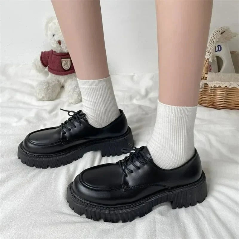Mocassins noirs à semelle épaisse portés avec des chaussettes blanches