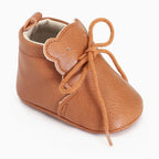 mocassin bébé marron à lacets avec détail ourson vu de trois quarts sur fond uni