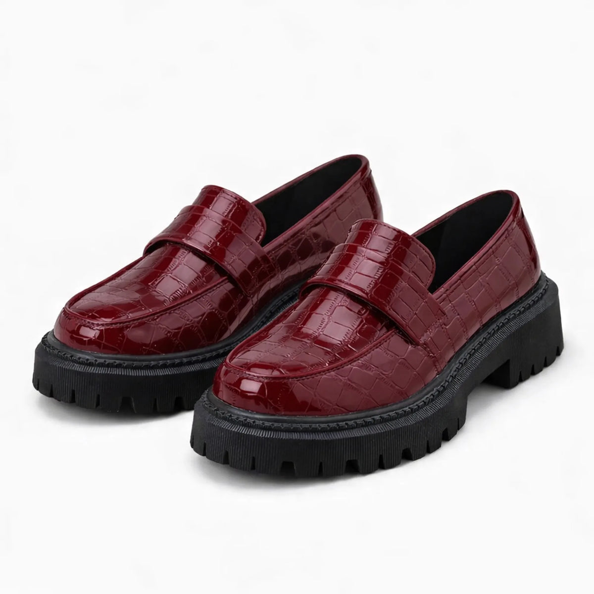 paire de mocassins vernis bordeaux posée sur fond uni clair