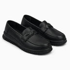 mocassin plat femme noir présenté seul sur fond uni clair
