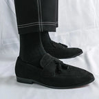 La paire noire portée avec pantalon noir et chaussettes montantes